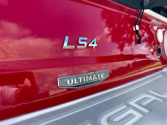 Slide: The Image of 2025 Regal LS4 Ultimate boat, red exterior, close-up view. - 21