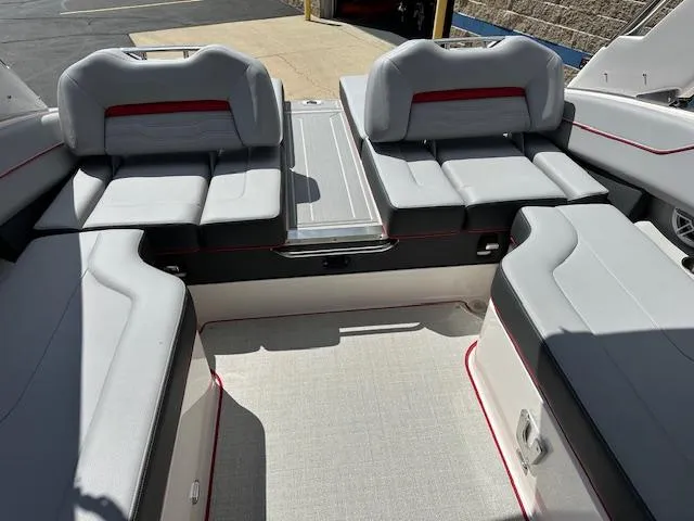 Slide: The Image of 2025 Regal LS4 boat interior with gray seating and red accents. - 22