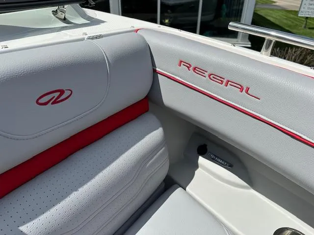 Slide: The Image of 2025 Regal LS4 boat interior with white and red upholstery detailing. - 25