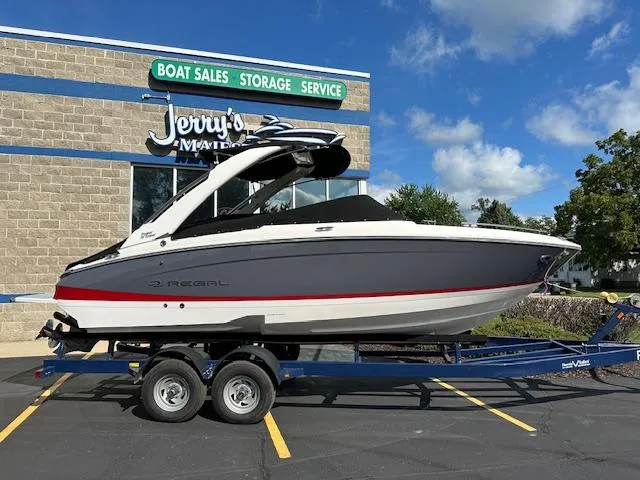 Slide: The Image of 2025 Regal LS4 boat on trailer at dealership under blue sky. - 30