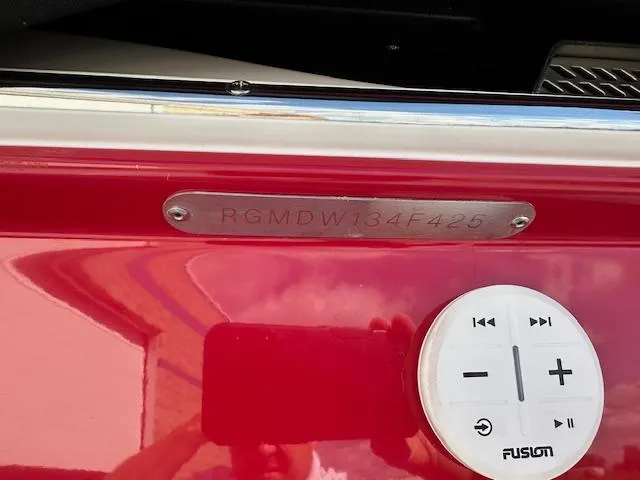 Slide: The Image of 2025 Regal LS4 boat with Fusion audio control and serial number plate. - 33
