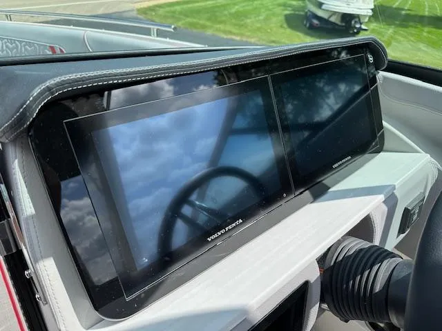 Slide: The Image of 2025 Regal LS4 dashboard with dual Volvo Penta displays, steering wheel reflection. - 6