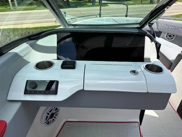 Slide: The Image of 2025 Regal LS4 boat interior with sleek dashboard and cup holders. - 9