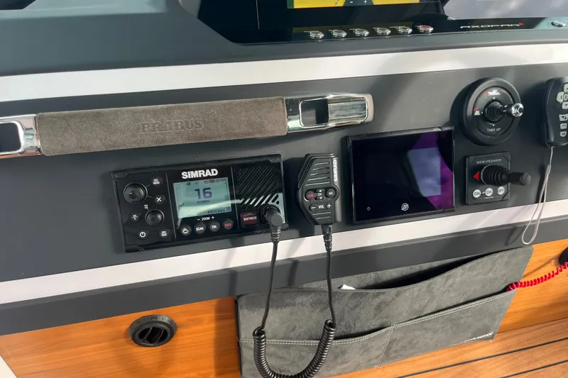 Slide: The Image of Axopar 28 CABIN 2022 dashboard with Simrad radio and navigation controls. - 21