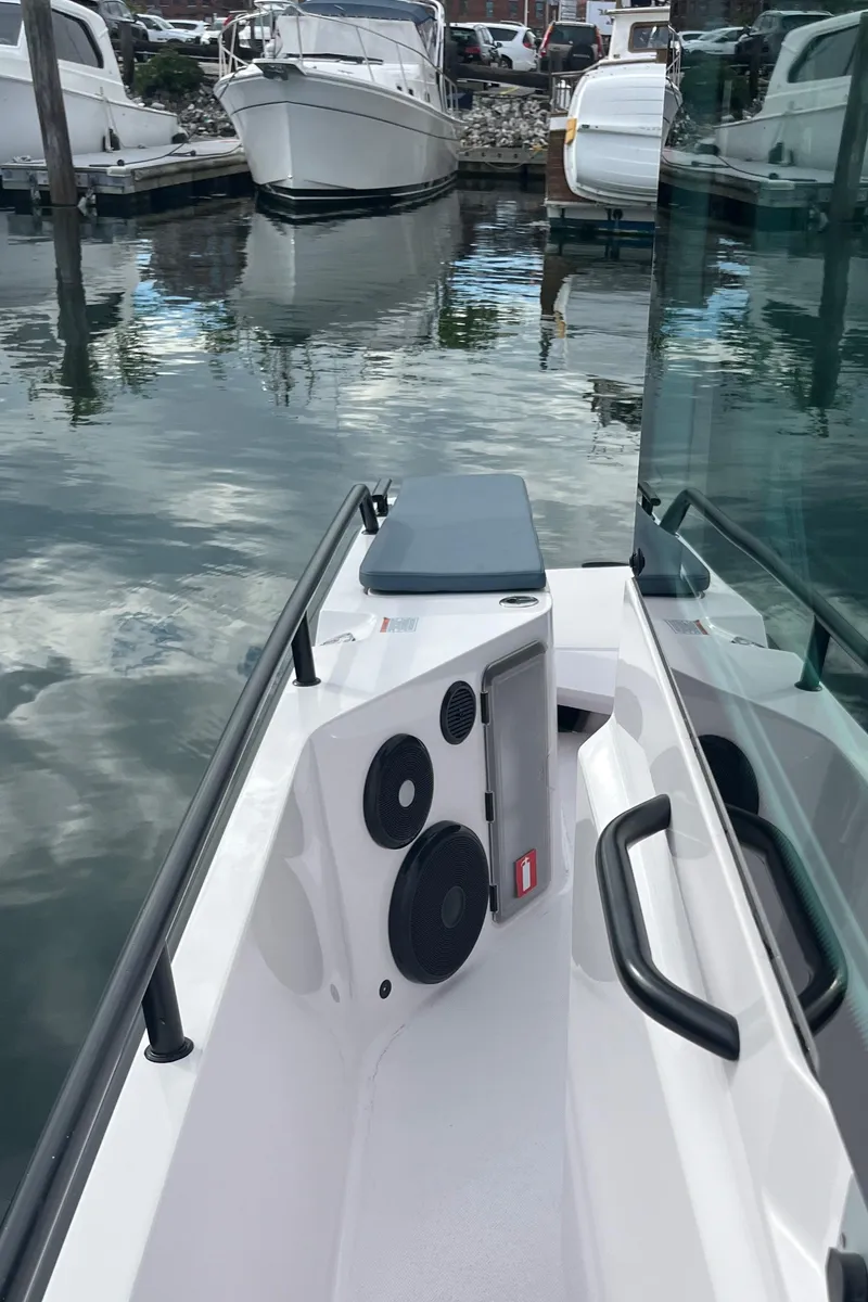 Slide: The Image of 2022 Axopar 28 CABIN boat docked at marina, featuring sleek design and modern amenities. - 33