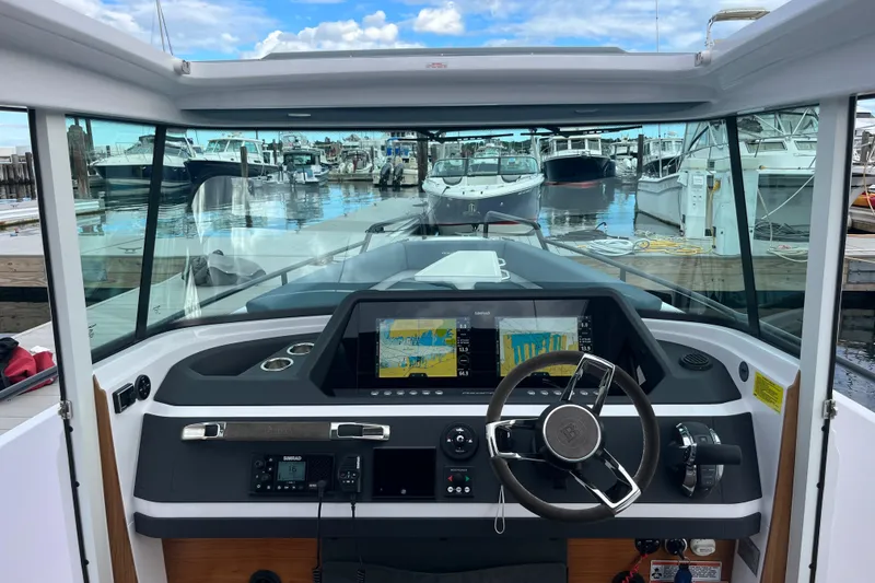 Slide: The Image of 2022 Axopar 28 CABIN boat dashboard with modern navigation system at marina. - 35