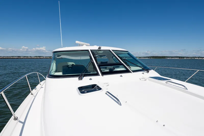 Slide: The Image of 2007 Tiara Yachts 4300 Sovran cruising on open water under clear skies. - 19