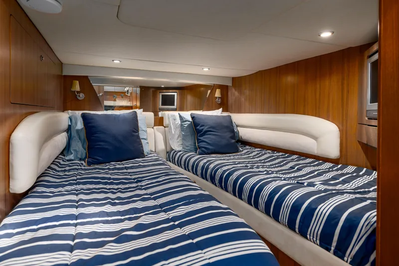 Slide: The Image of Luxurious 2007 Tiara Yachts 4300 Sovran cabin with twin beds and elegant wood paneling. - 35