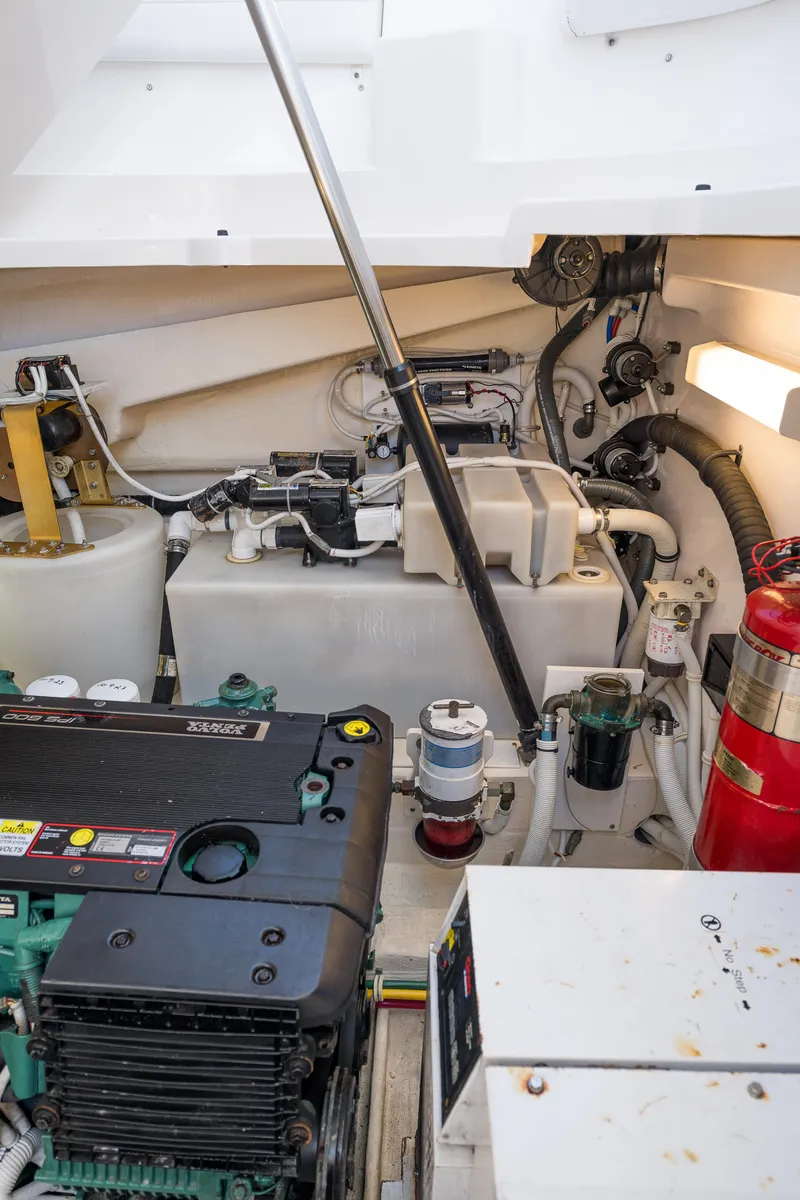 Slide: The Image of Engine room of 2007 Tiara Yachts 4300 Sovran, showcasing mechanical components and fire extinguisher. - 44