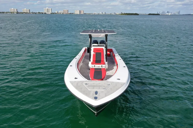 Slide: The Image of 2004 Contender 31 Tournament boat on open water, city skyline in background. - 1