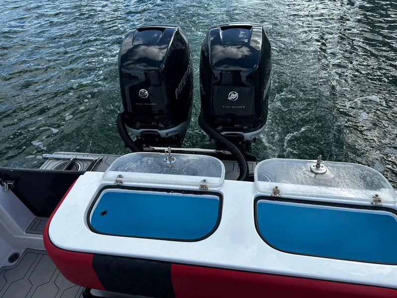 Slide: The Image of 2004 Contender 31 Tournament boat with dual Mercury outboard engines on water. - 10