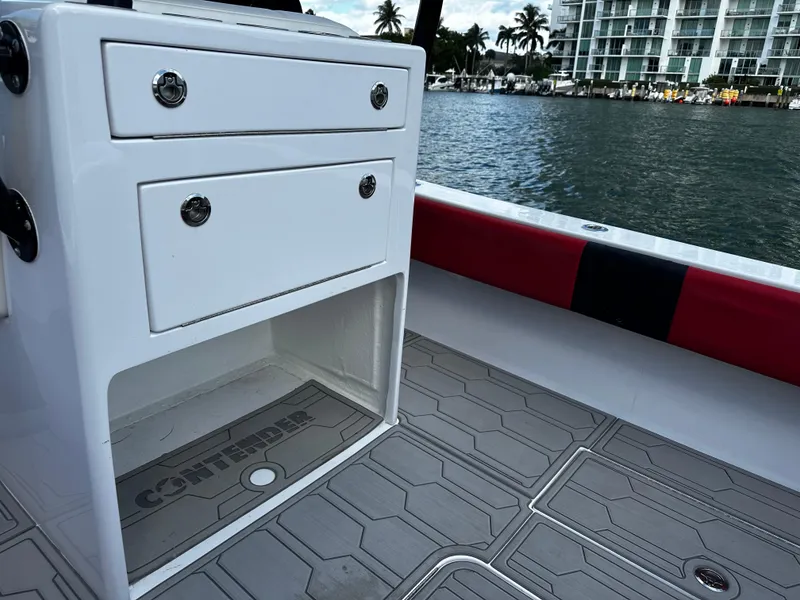 Slide: The Image of 2004 Contender 31 Tournament boat interior with storage drawers, near waterfront buildings. - 11