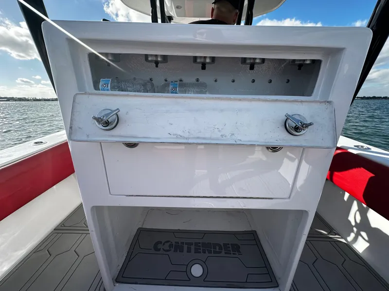 Slide: The Image of 2004 Contender 31 Tournament boat console with storage and rod holders. - 14