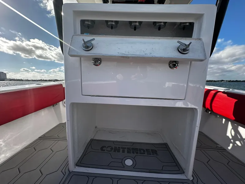 Slide: The Image of 2004 Contender 31 Tournament boat console with storage, ocean view, and red seating. - 15