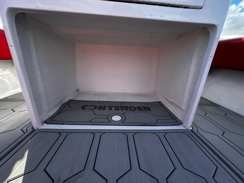 Slide: The Image of Contender 31 Tournament 2004 boat storage compartment with branded mat and textured flooring. - 17