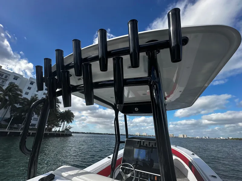 Slide: The Image of 2004 Contender 31 Tournament boat with rod holders, ocean view, and clear blue sky. - 18