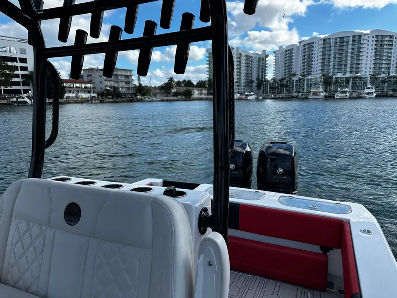 Slide: The Image of 2004 Contender 31 Tournament boat on water, cityscape in background. - 19