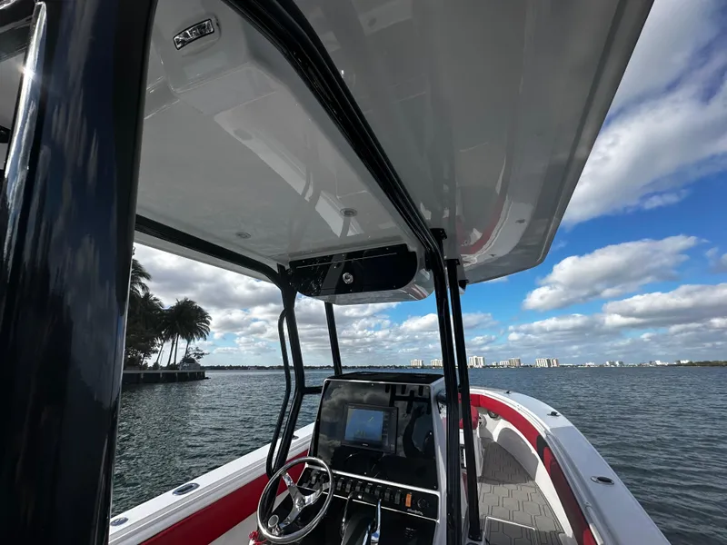 Slide: The Image of 2004 Contender 31 Tournament boat on water, clear sky, palm trees in background. - 20