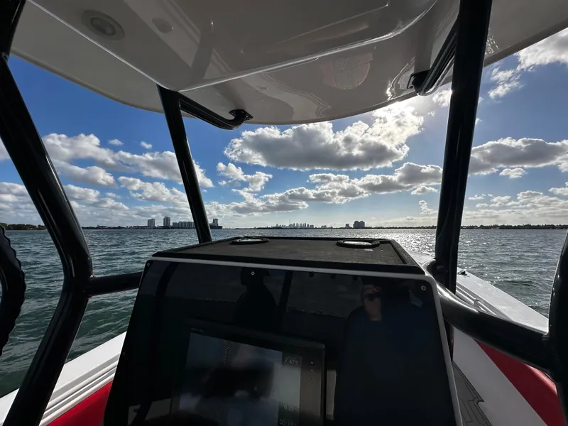 Slide: The Image of 2004 Contender 31 Tournament boat on open water under a partly cloudy sky. - 21