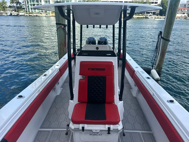 Slide: The Image of 2004 Contender 31 Tournament boat with red and black seating, docked by the water. - 27