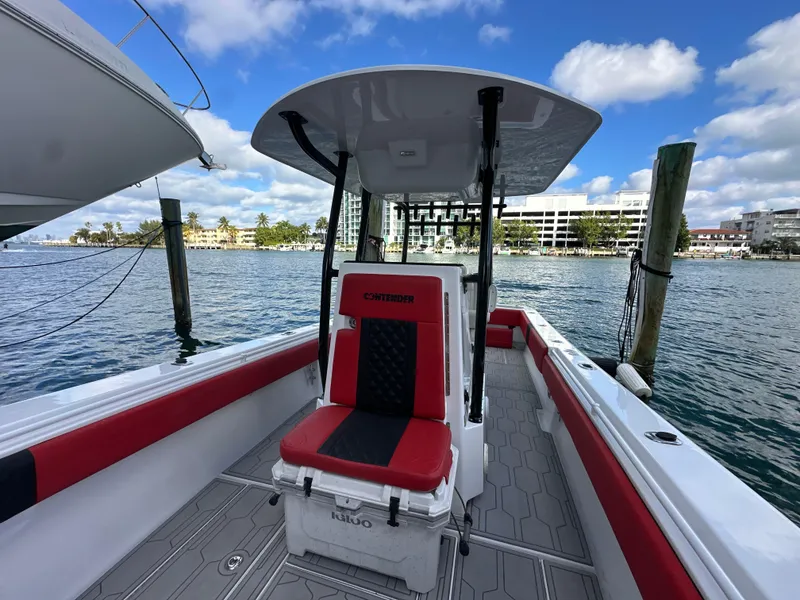 Slide: The Image of 2004 Contender 31 Tournament boat with red and black seating, docked by the water. - 28