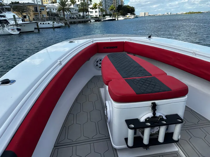 Slide: The Image of 2004 Contender 31 Tournament boat with red seating, docked by waterfront buildings. - 30