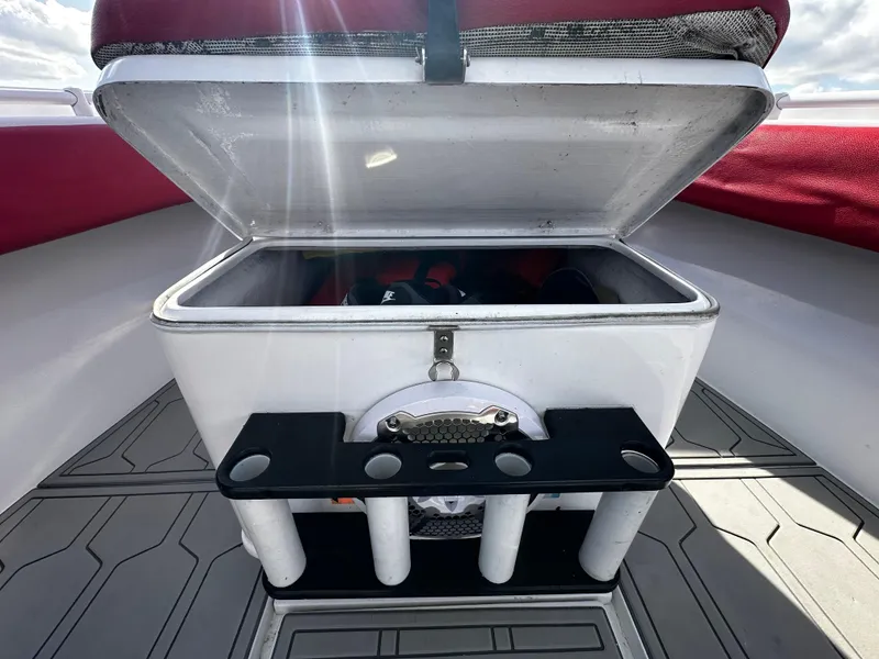 Slide: The Image of Open storage compartment on 2004 Contender 31 Tournament boat with rod holders. - 33