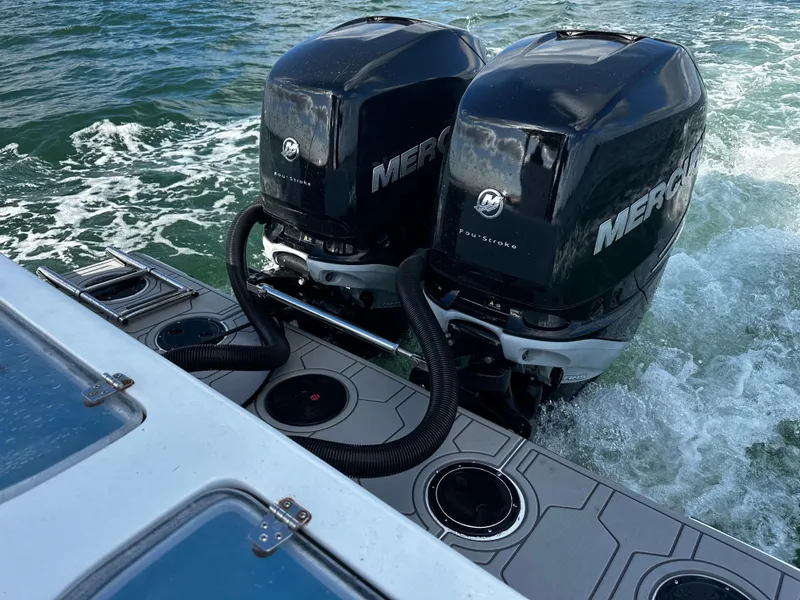 Slide: The Image of 2004 Contender 31 Tournament boat with dual Mercury outboard engines on the water. - 6