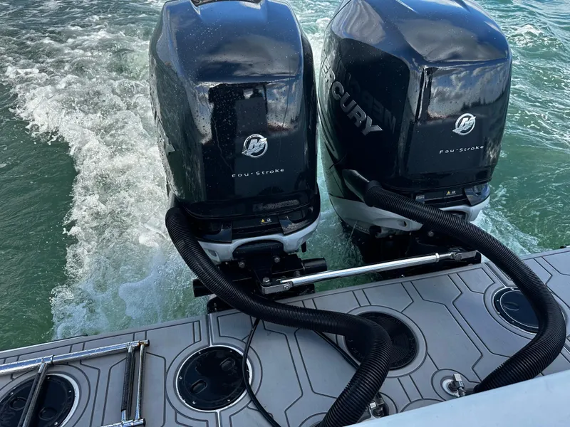 Slide: The Image of 2004 Contender 31 Tournament boat with dual Mercury outboard engines on water. - 8