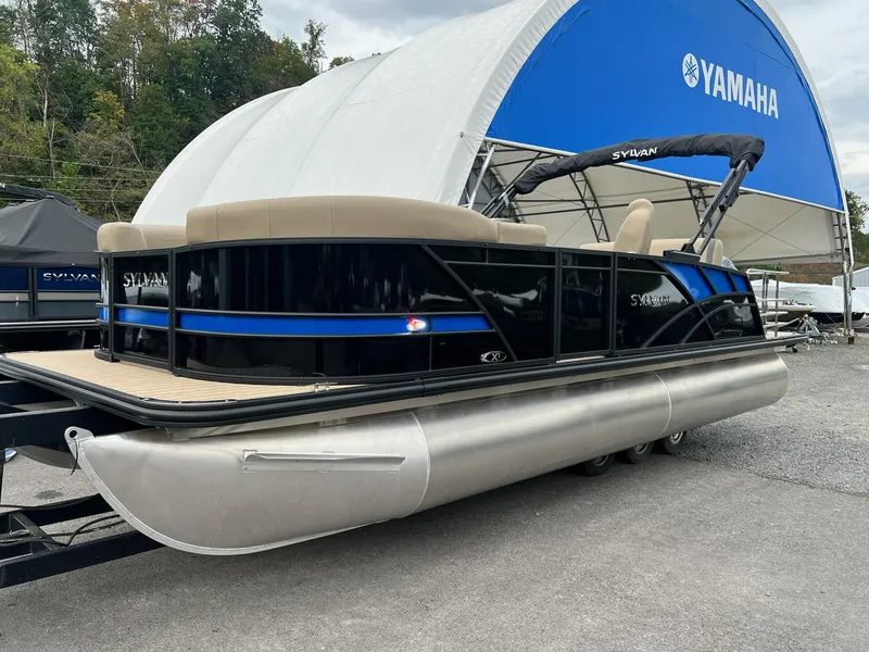 Slide: The Image of 2025 Sylvan X3 CLZ DH Mirage Tritoon boat displayed at Yamaha dealership. - 17