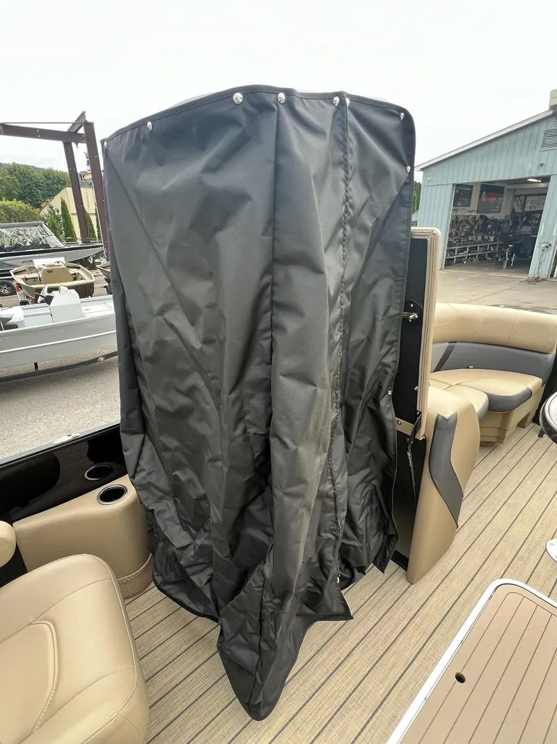 Slide: The Image of 2025 Sylvan X3 CLZ DH Mirage Tritoon interior with privacy curtain and seating. - 19