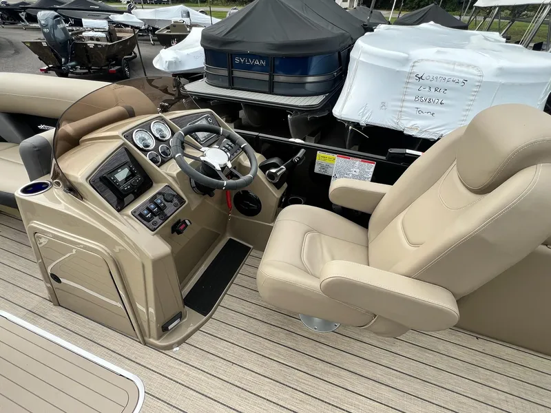Slide: The Image of Interior view of 2025 Sylvan X3 CLZ DH Mirage Tritoon boat with beige captain's chair. - 20