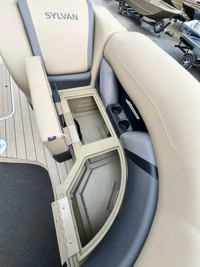Slide: The Image of 2025 Sylvan X3 CLZ DH Mirage Tritoon with open storage compartment. - 22