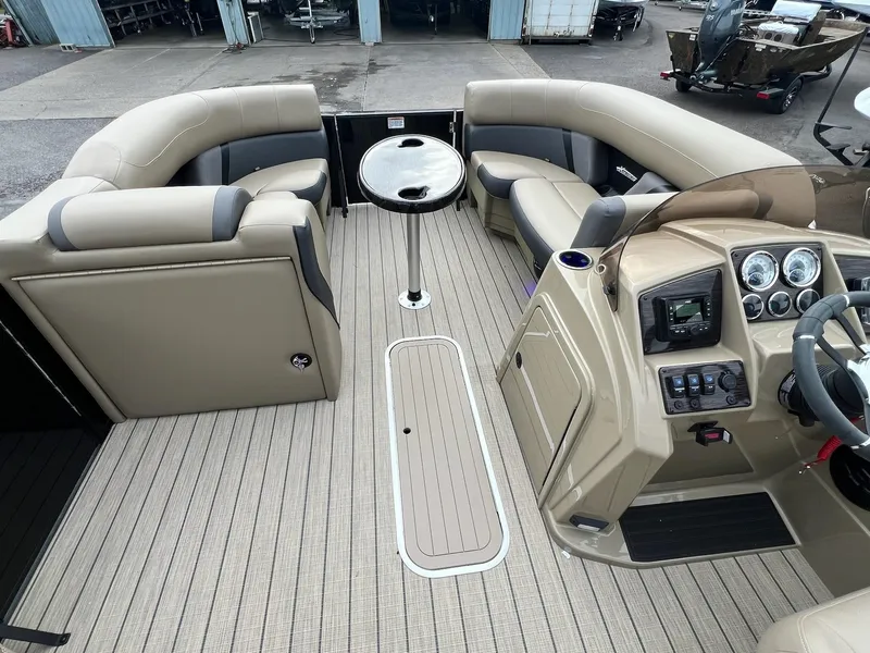 Slide: The Image of 2025 Sylvan X3 CLZ DH Mirage Tritoon interior with beige seating and modern dashboard. - 23