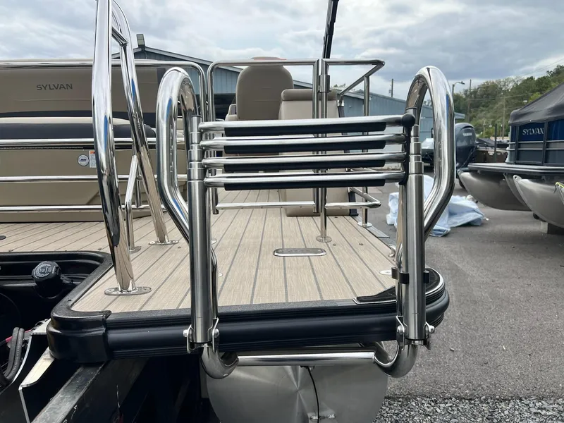 Slide: The Image of 2025 Sylvan X3 CLZ DH Mirage Tritoon with stainless steel ladder and deck. - 26