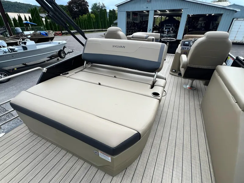 Slide: The Image of 2025 Sylvan X3 CLZ DH Mirage Tritoon interior with beige seating and modern design. - 27