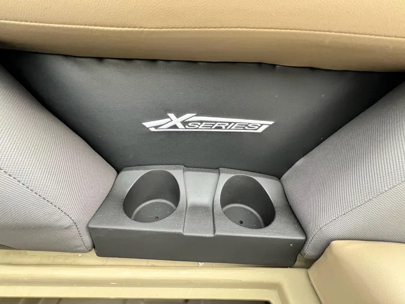 Slide: The Image of Cup holders and "X Series" logo in 2025 Sylvan X3 CLZ DH Mirage Tritoon. - 28