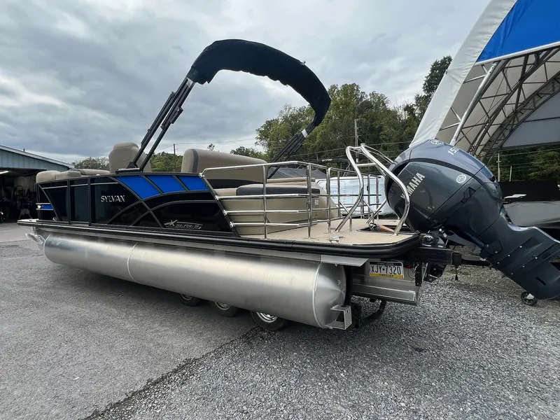 Slide: The Image of 2025 Sylvan X3 CLZ DH Mirage Tritoon with Yamaha engine, parked outdoors. - 29