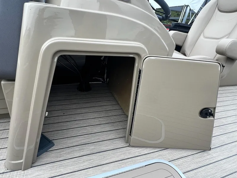 Slide: The Image of Open storage compartment on 2025 Sylvan X3 CLZ DH Mirage Tritoon boat. - 3