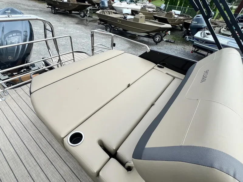 Slide: The Image of 2025 Sylvan X3 CLZ DH Mirage Tritoon with beige seating and cup holders. - 30