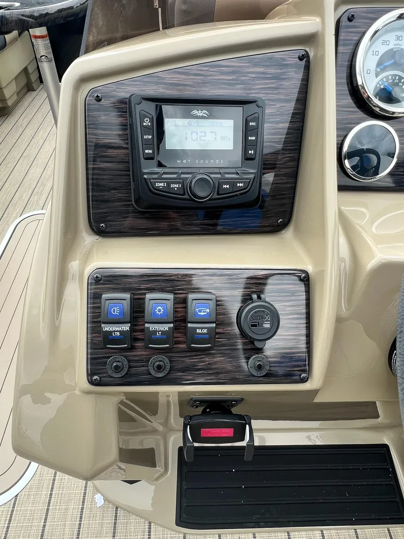 Slide: The Image of Control panel of 2025 Sylvan X3 CLZ DH Mirage Tritoon with radio and switches. - 38