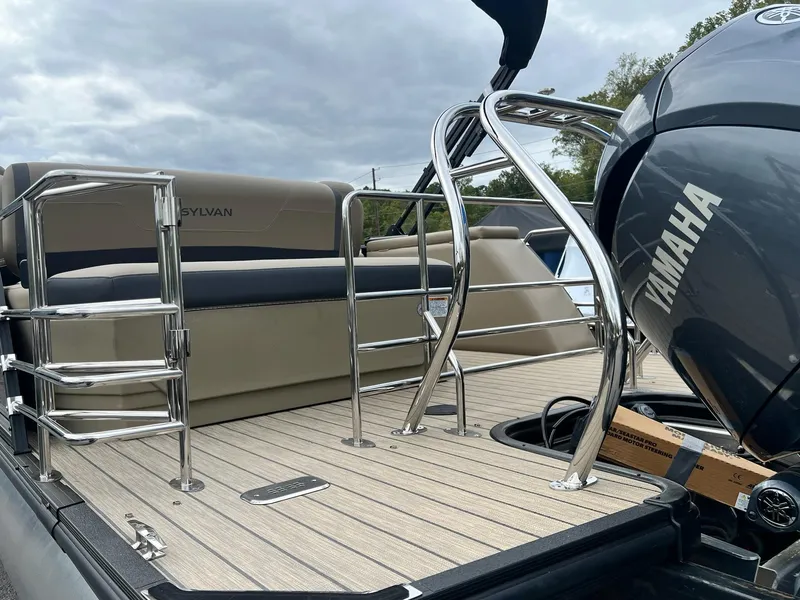 Slide: The Image of 2025 Sylvan X3 CLZ DH Mirage Tritoon with Yamaha engine, featuring sleek deck and seating. - 4