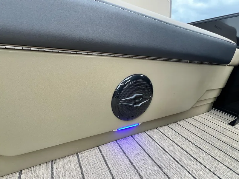 Slide: The Image of 2025 Sylvan X3 CLZ DH Mirage Tritoon interior with speaker and blue LED lighting. - 40