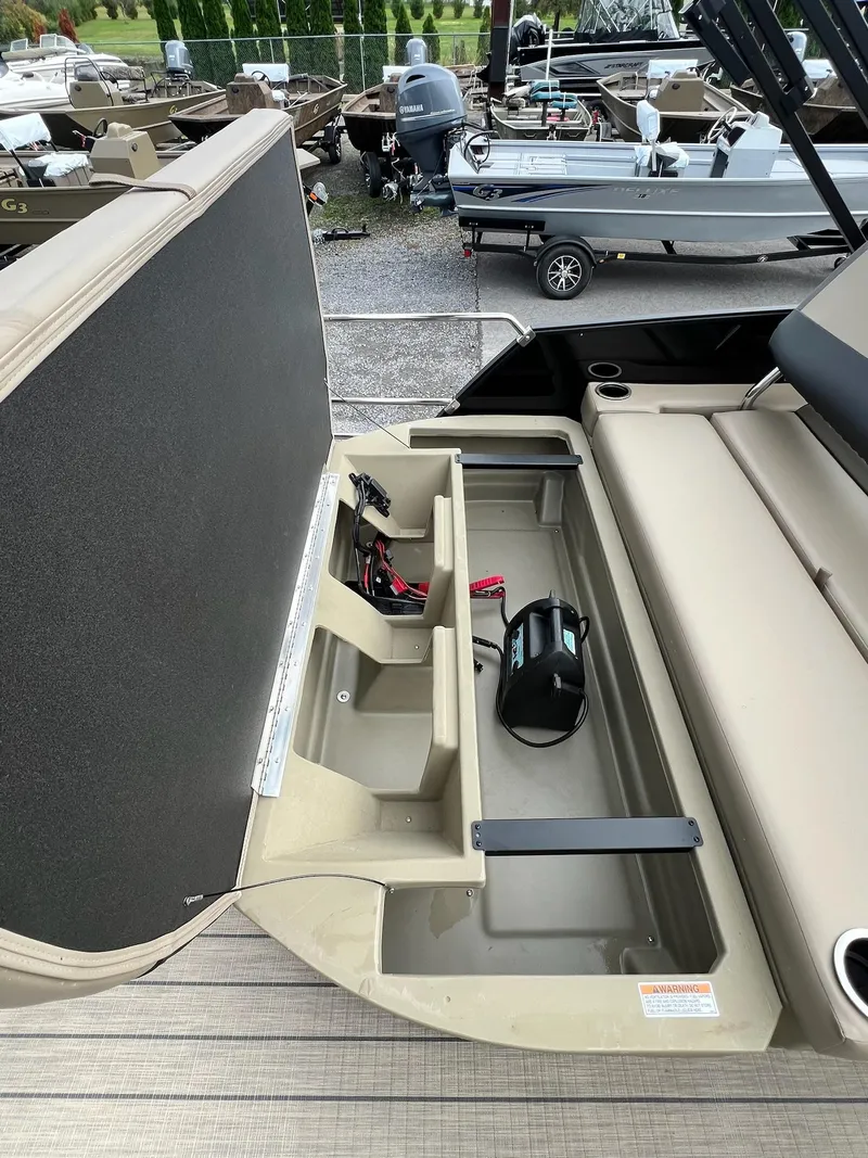 Slide: The Image of 2025 Sylvan X3 CLZ DH Mirage Tritoon storage compartment with open seat and equipment. - 42