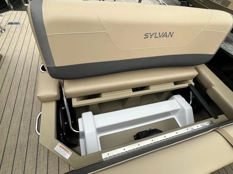 Slide: The Image of 2025 Sylvan X3 CLZ DH Mirage Tritoon seat storage compartment, beige upholstery. - 44