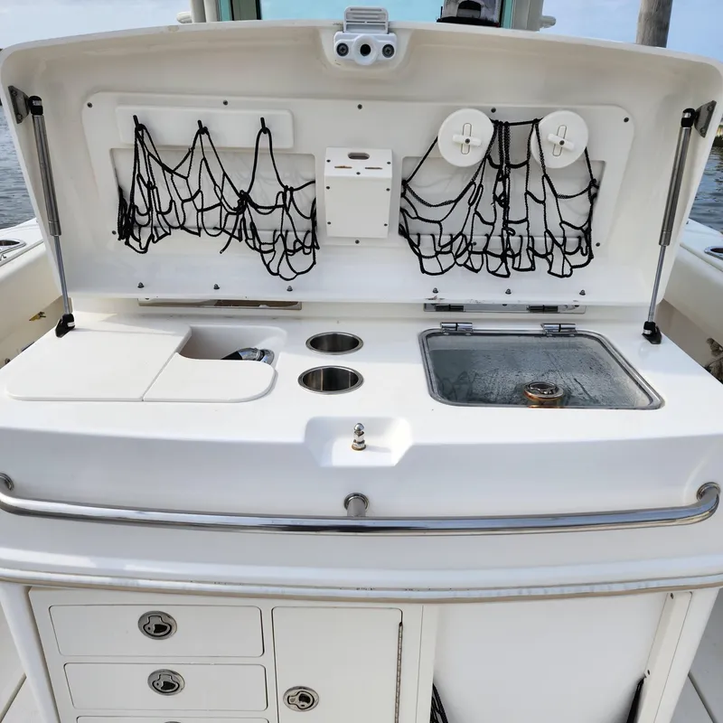 Slide: The Image of 2010 Boston Whaler 320 Outrage boat with fishing station and storage compartments. - 10