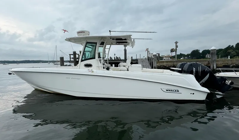 Slide: The Image of 2010 Boston Whaler 320 Outrage boat docked at marina. - 2