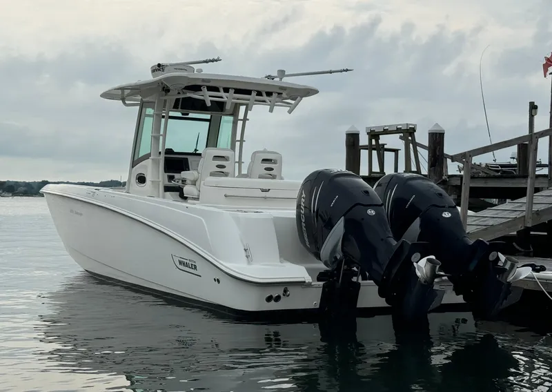 Slide: The Image of 2010 Boston Whaler 320 Outrage boat docked with twin outboard engines. - 3