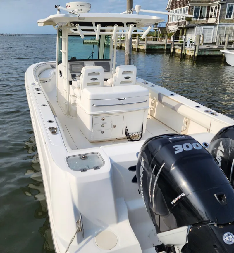 Slide: The Image of 2010 Boston Whaler 320 Outrage boat docked, featuring twin 300 HP engines. - 4