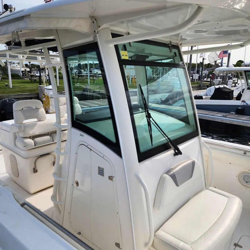 Slide: The Image of 2010 Boston Whaler 320 Outrage boat interior with seating and windshield. - 6